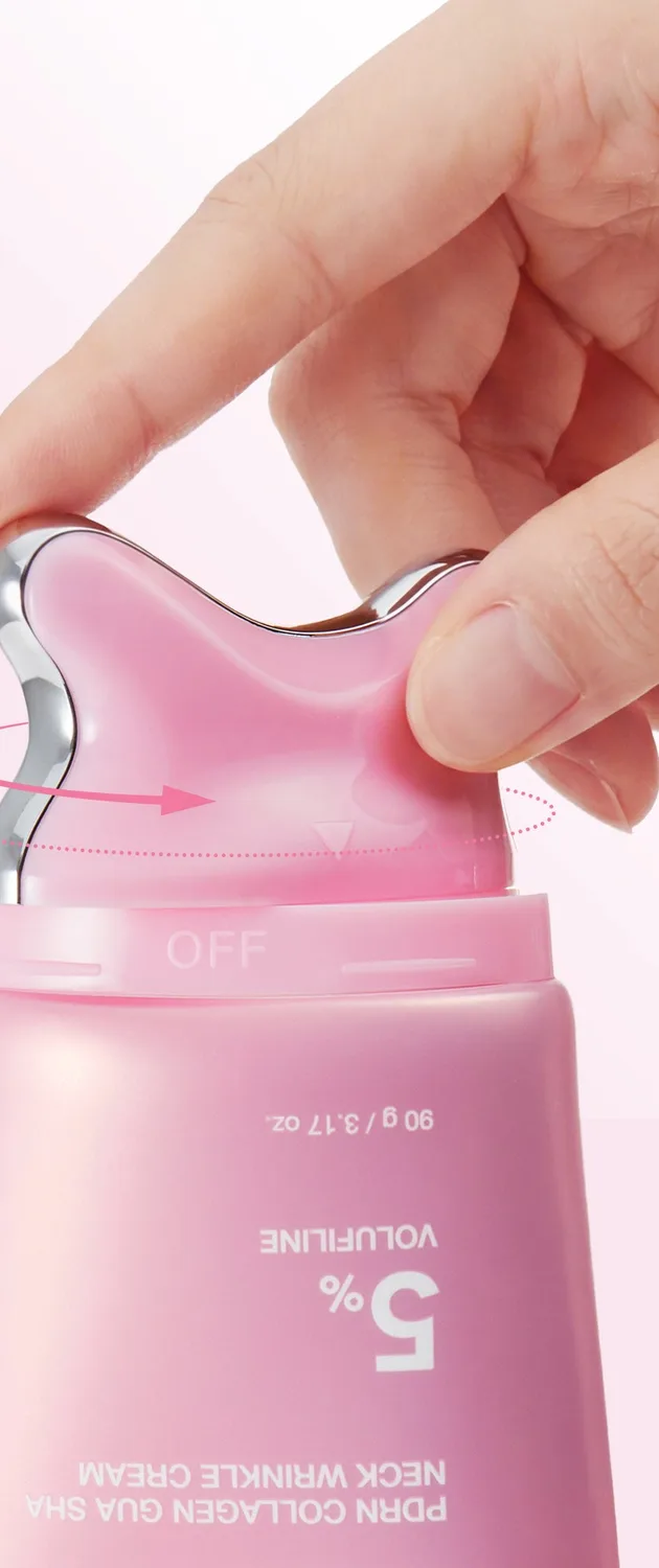A hand twisting open the silver-rimmed pink gua sha head on top of the medicube neck cream tube