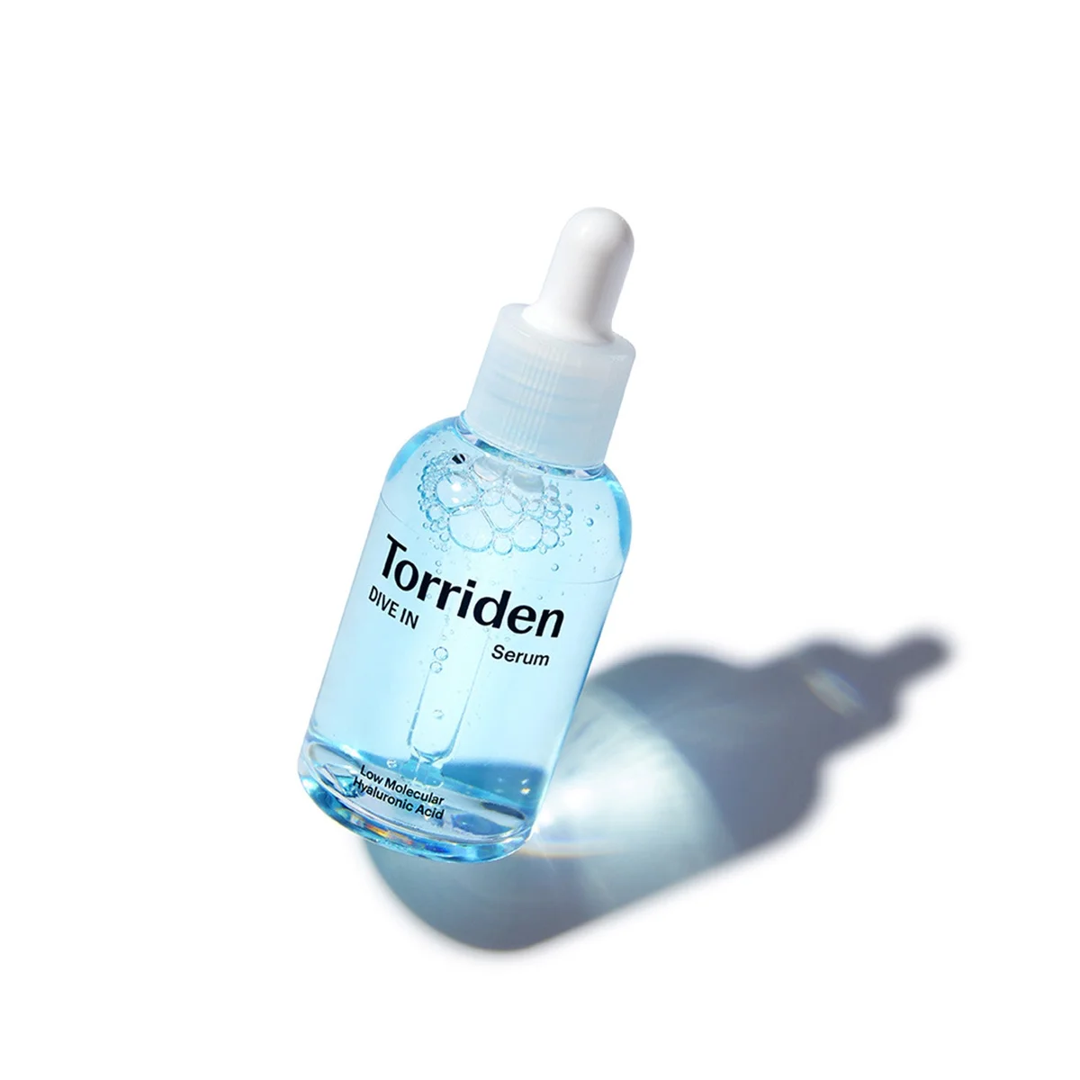 Torriden DIVE IN Serum, a clear bottle of pale blue serum with a white dropper cap and black Torriden lettering, on a white background